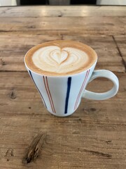 Heart Art on cup of soy latte on a wooden table in Shibuya, Tokyo, Japan