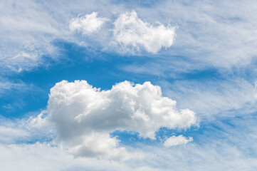 A combination of white high and medium cloud in the blue sky