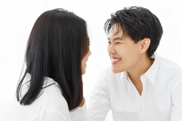 LGBTQ couple lovers, a handsome girl as man or butch and femme, spending and sharing loving time in...