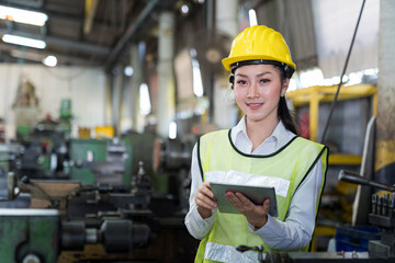 Manufacturing worker using Computer tablet at work. Asian worker controlling the work.