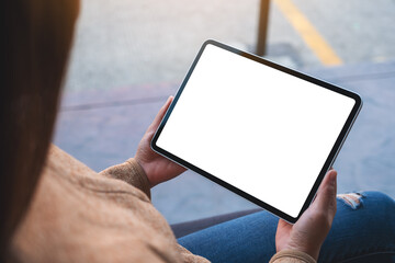 Mockup image of a woman holding digital tablet with blank white desktop screen