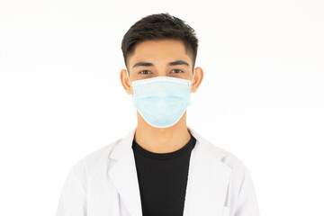A young and handsome Asian teen man wearing the protective hygiene mask on face and looking to camera on white background. Idea for safety and health care during coronavirus spreading
