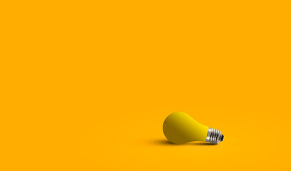 idea concept minimal light bulb in orange clean background.  Yellow light-bulb on the ground  conceptual minimal. yellow light-bulb with space. 