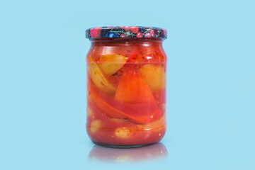 Fototapeta na wymiar lecho salad in a jar on a blue