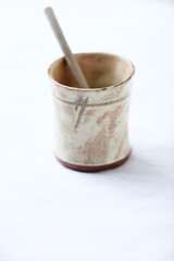 Traditional, handcrafted ceramic on bright wooden background. Soft focus. Close up