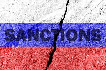 The flag of the Russian Federation on a cracked cement wall with the words 
