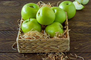 Zero waste concept. No plastic concept. water hyacinth box with ripe green apples on wooden background.
