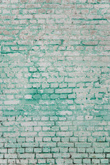 grunge background: faded brick wall with whitewash and remnants of green paint