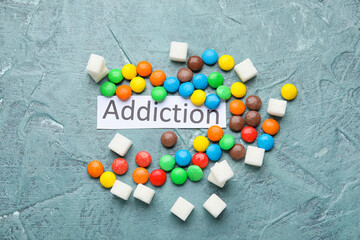 Different sweets on color background. Concept of addiction