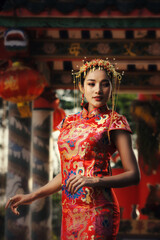 Fototapeta na wymiar Beautiful asian woman in chinese dress traditional with congratulate gesture in Chinese New Year.