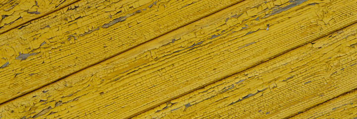 old rough boards covered with cracked gold paint