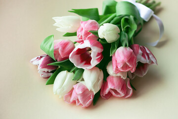 Bouquet of tulips in pink and white colors. Concept of spring, Women's Day, Mother's Day, 8 March, the holiday greetings. Copy space, flat lay.