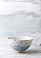Traditional ceramic bowl on bright background. Copy space.