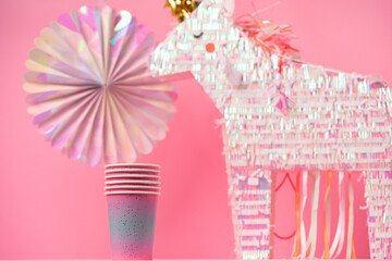 Unicorn pinata for kids party on pink background