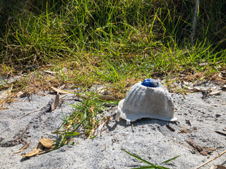 n95 mask left in the sand dunes on the beach