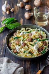 Linguine pasta with mushrooms, white cheese, spinach and garlic. Healthy eating. Vegetarian food. Diet.