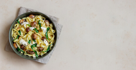 Linguine pasta with mushrooms, white cheese, spinach and garlic. Healthy eating. Vegetarian food. Diet.