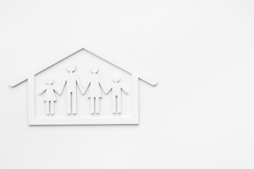Family at home concept. Wooden family figure in white house. Top view