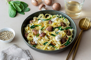 Linguine pasta with mushrooms, white cheese, spinach and garlic. Healthy eating. Vegetarian food. Diet.