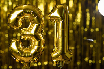 The golden number 31 thirty one is made from an inflatable balloon on a yellow background. One of the complete set of numbers. Birthday, anniversary, date concept