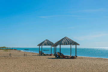Fototapeta premium Couple of huts on a tropical beach under a bright sun