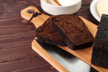 Sliced rye bread on brown wooden background