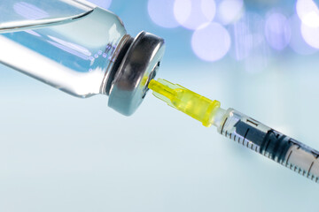 Vaccine vial dose flu shot drug needle syringe on blue background. Medical concept vaccination...