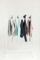 Stylish and comfortable clothes for teenagers hang on a hanger. Clothes for convenience on a white background