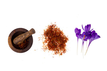 Spice saffron and fresh crocus flowers isolated on white background.