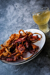 Sun dried pork and Pork snack on white plate with ice tea. Thai food.