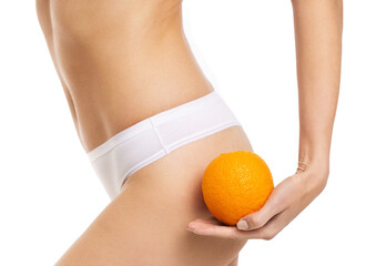 beautiful slim female waist on a white background with orange