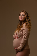 Pregnant girl on a light background