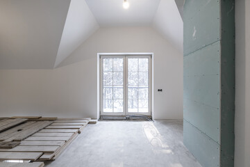 empty white room with mansard without repair and furniture with scaffolding