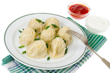 Boiled hot khinkali with meat, spices and ketchup.