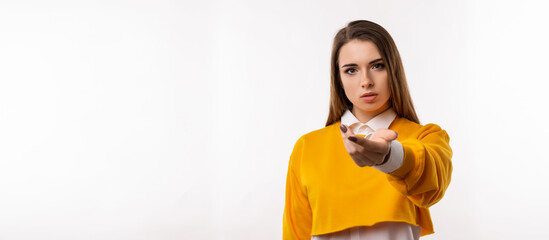 Portrait of pretty girl reaching palm of hand to the camera giving assistance and acceptance