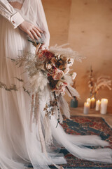 Boho style wedding bouquet in shades of brown, beige and white.