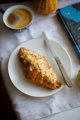 almond croissant on a white plate