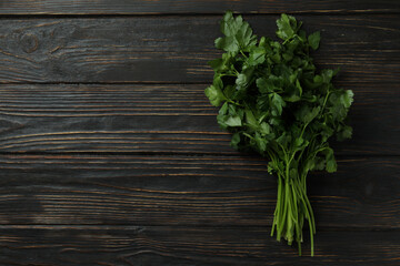 Fresh green parsley on wooden background, space for text