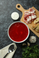 Concept of tasty eating with borscht on black smokey background