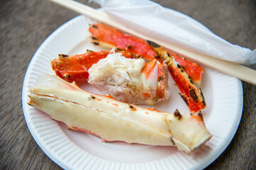 Tokyo, Japan Street in Tsukiji outer market in Ginza with closeup retail sample display of cooked red crab lobster legs white meat.