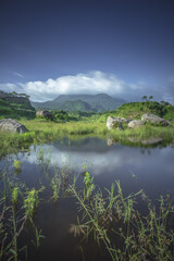 Fototapeta na wymiar Ranu Manduro of Indonesia with Penanggungan Mountain Reflection. Early Morning