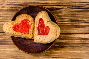 Pastry made in shape of heart on the wooden background