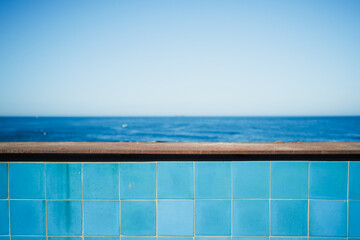 wall with blue tiles in front of sea