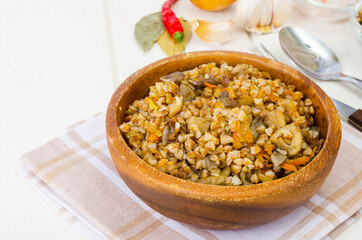 Boiled buckwheat porridge with stewed mushrooms and vegetables.