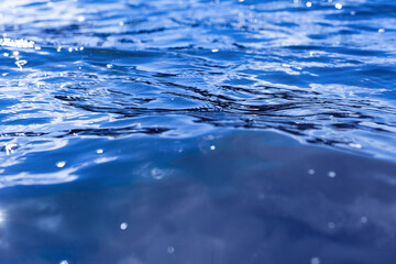 Ripples on the water. A small wave. Blue water