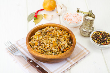 Boiled buckwheat porridge with stewed mushrooms and vegetables.