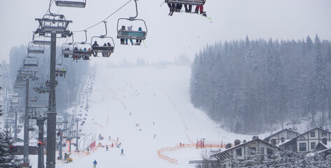 People are lifting on ski-lift in the mountains