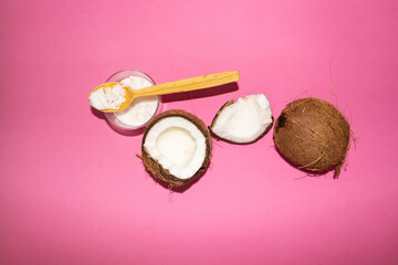 Half of coconuts isolated on color background. Coconut cream. Top View. Flat lay.