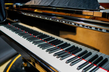 Close-up of the black and white keys of a top grand piano