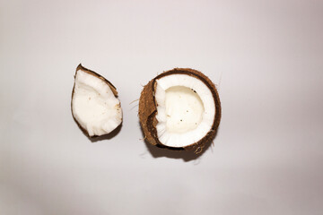 Half of coconuts isolated on color background. Coconut cream. Top View. Flat lay.